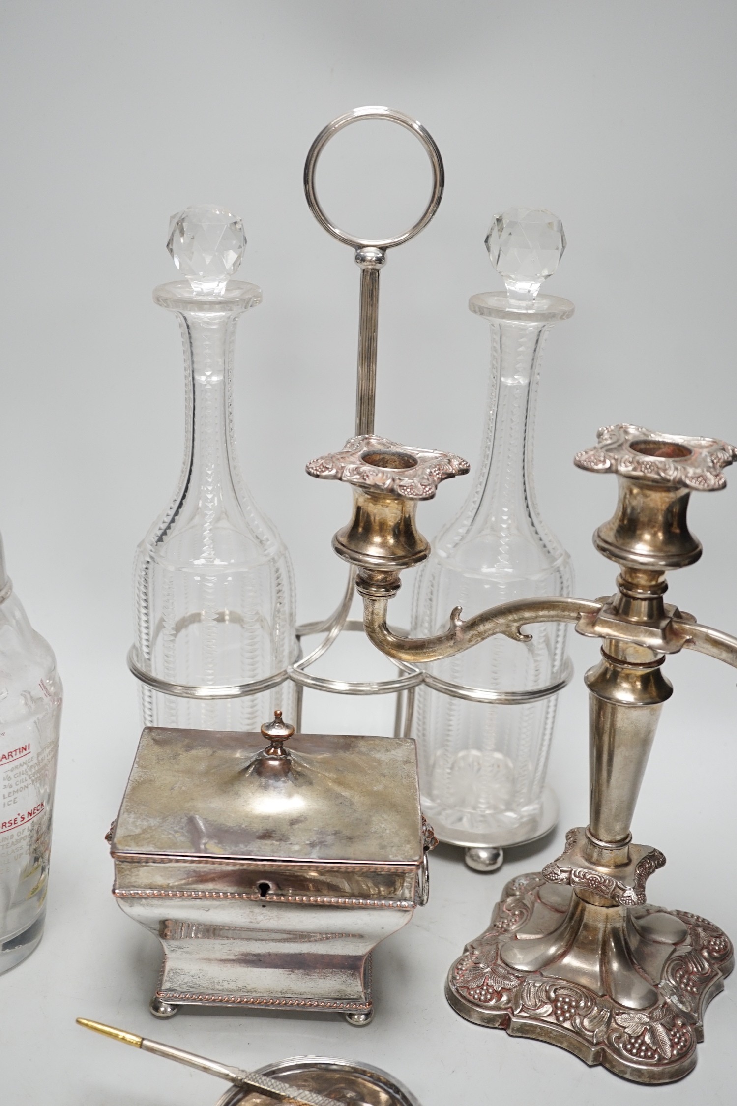 Assorted plated items including a decanter stand with two bottles, by Hukin & Heath and a tea caddy etc.